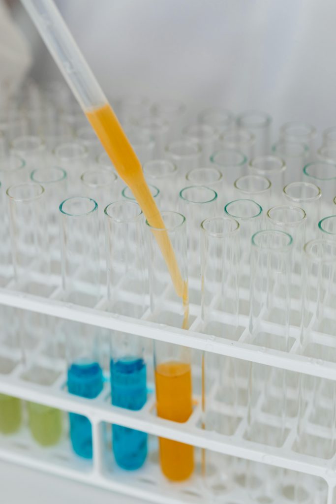 pexels-photo-8540033-8540033 Close-up of a pipette adding liquid to test tubes in a laboratory.